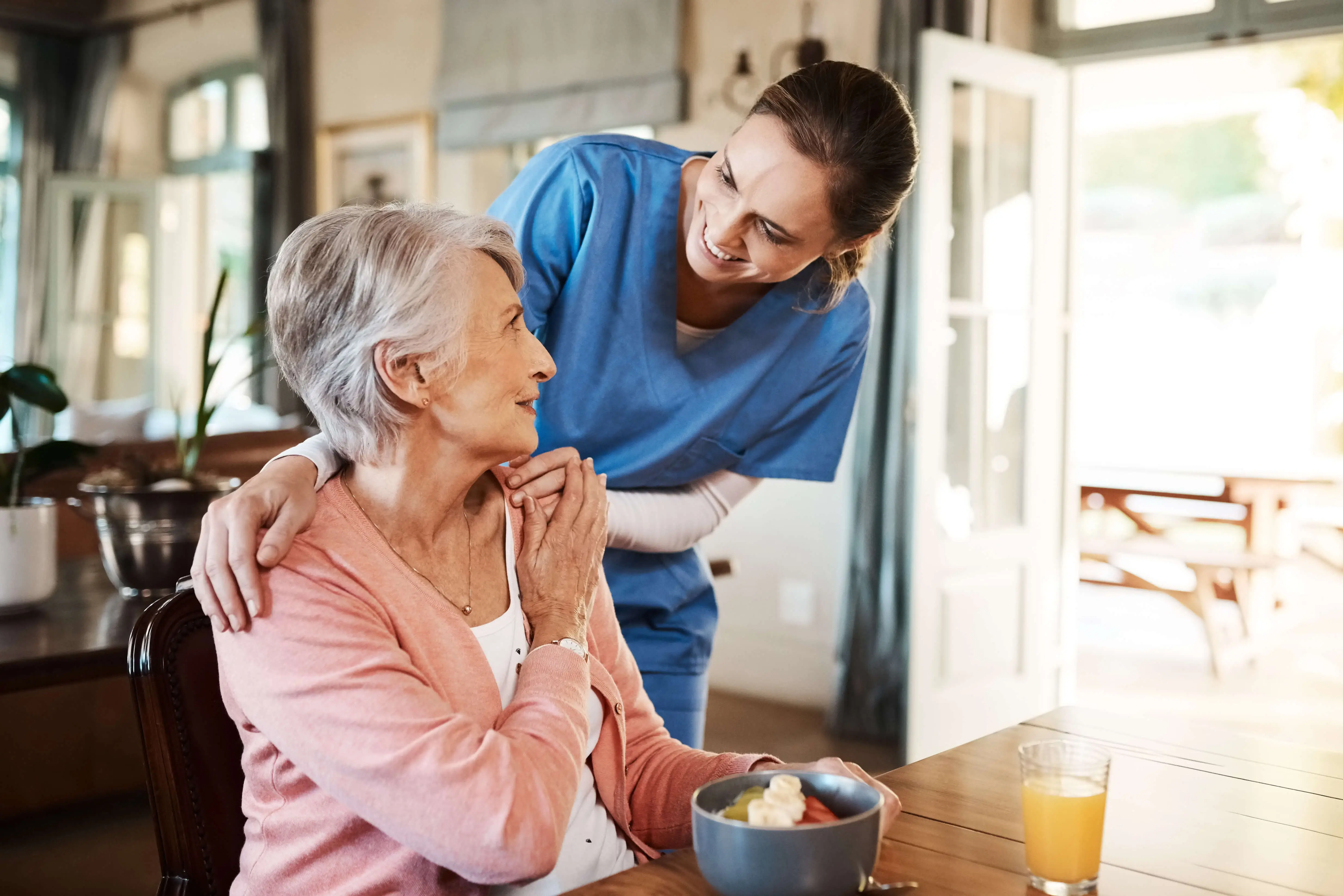 OC HomeCare caregiver assisting senior woman with healthy mealtime support at home in Placentia, CA – Providing compassionate in-home care and companionship