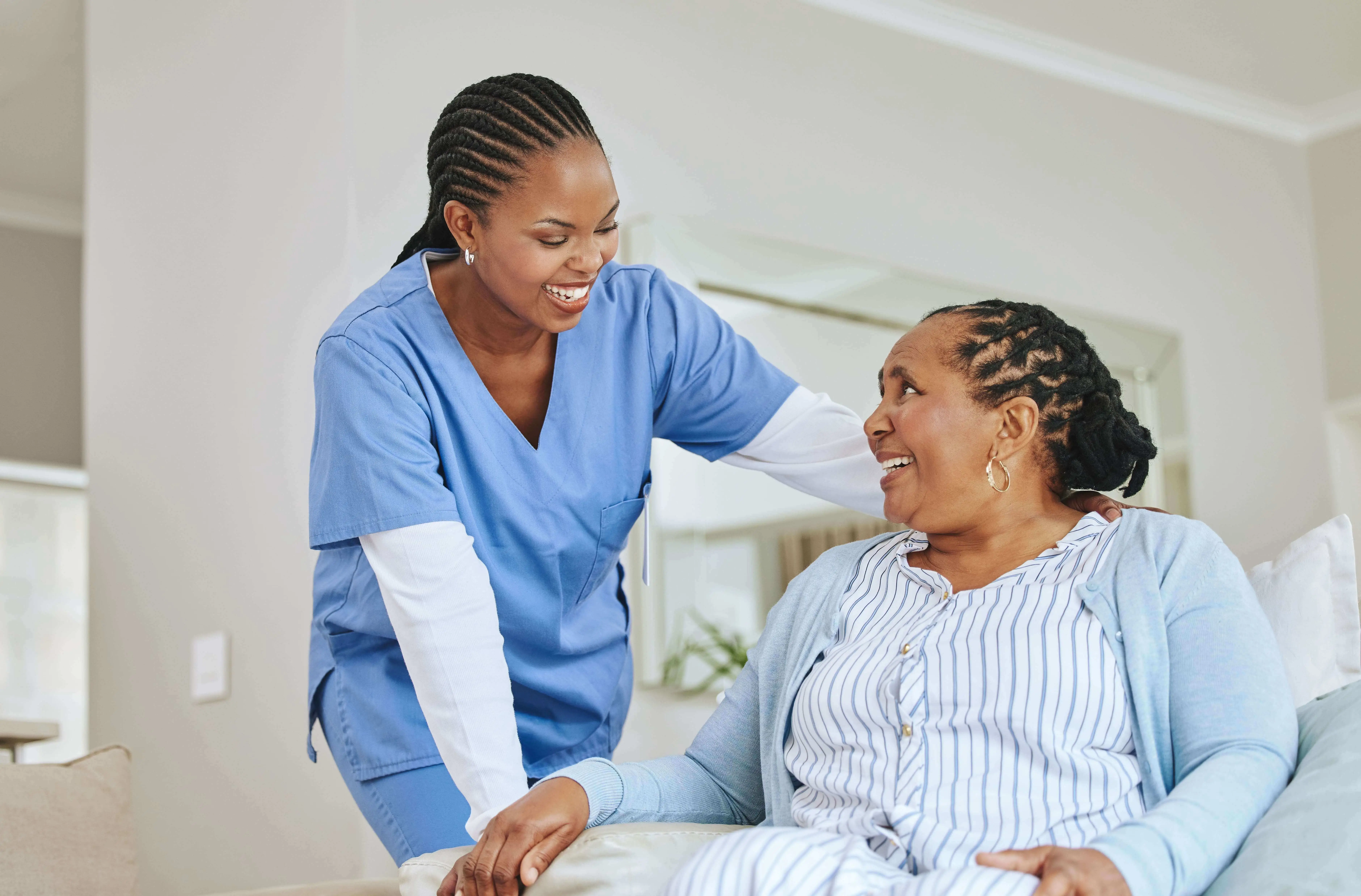 OC HomeCare caregiver providing personalized assisted living support to a smiling senior woman in her Dana Point, CA home – Trusted residential senior care in a coastal community
