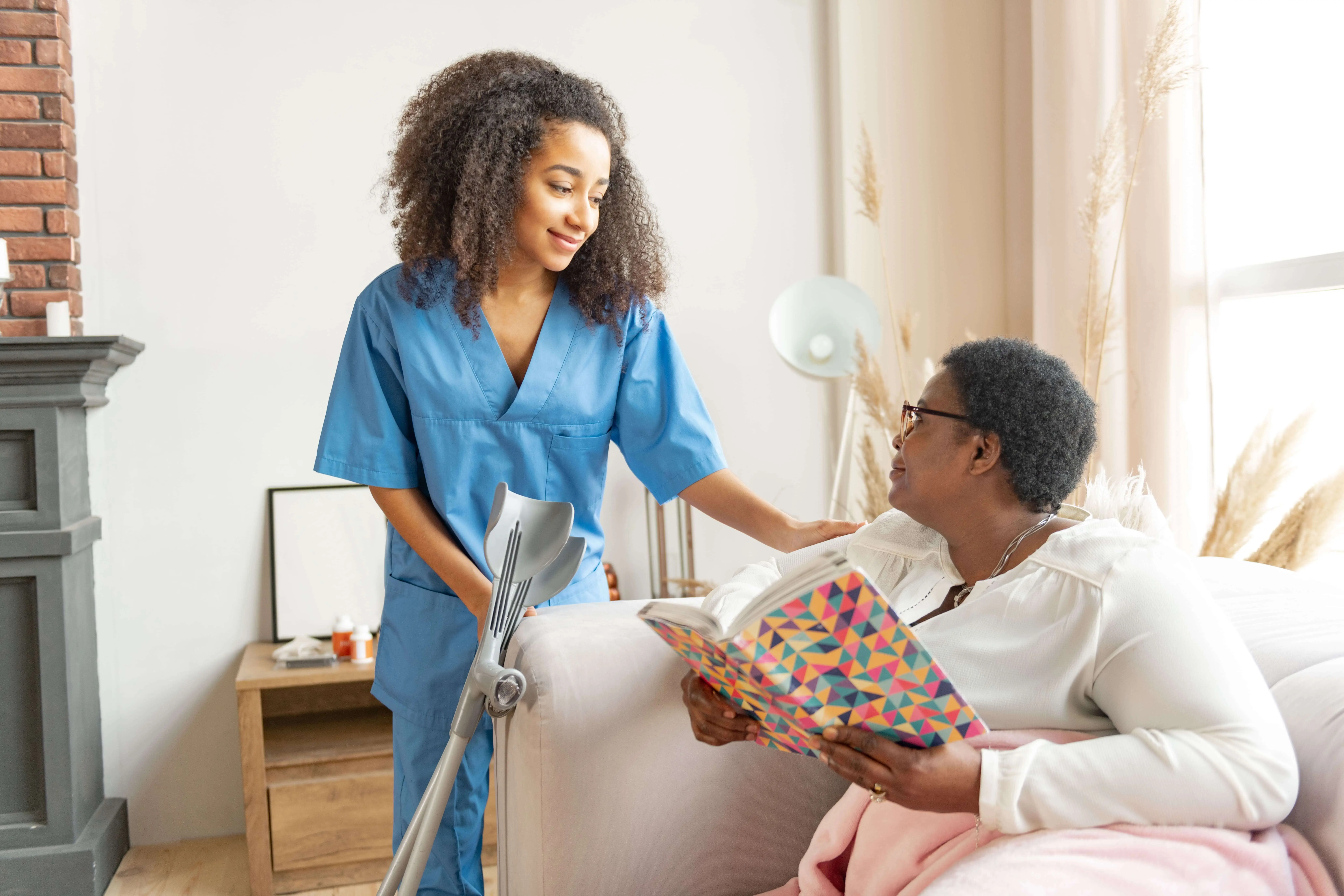 OC HomeCare caregiver assisting senior woman with mobility support and personal care in a cozy Costa Mesa residential care home