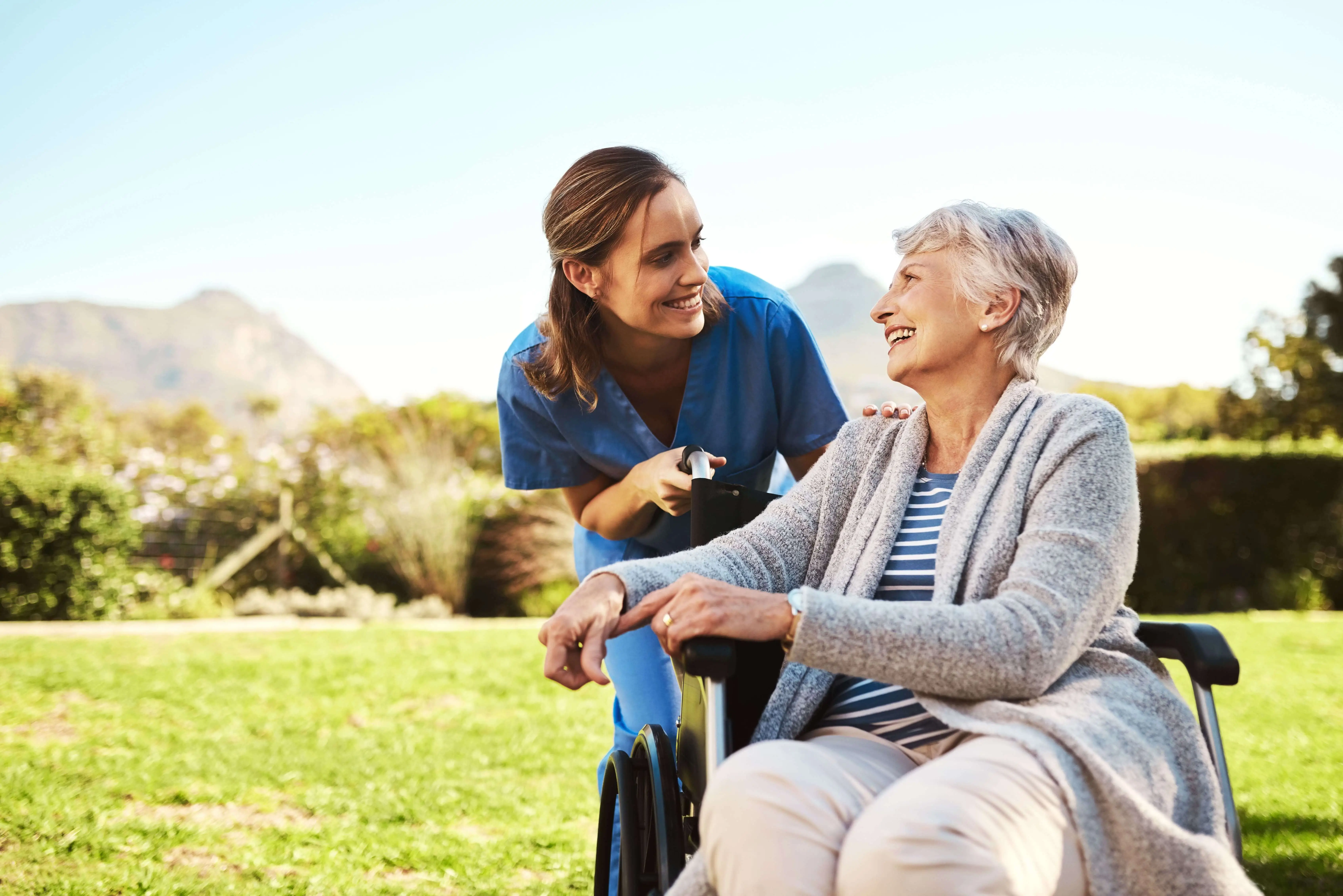 OC HomeCare caregiver smiling with senior woman in wheelchair during in-home care visit in Lake Forest, Orange County, CA