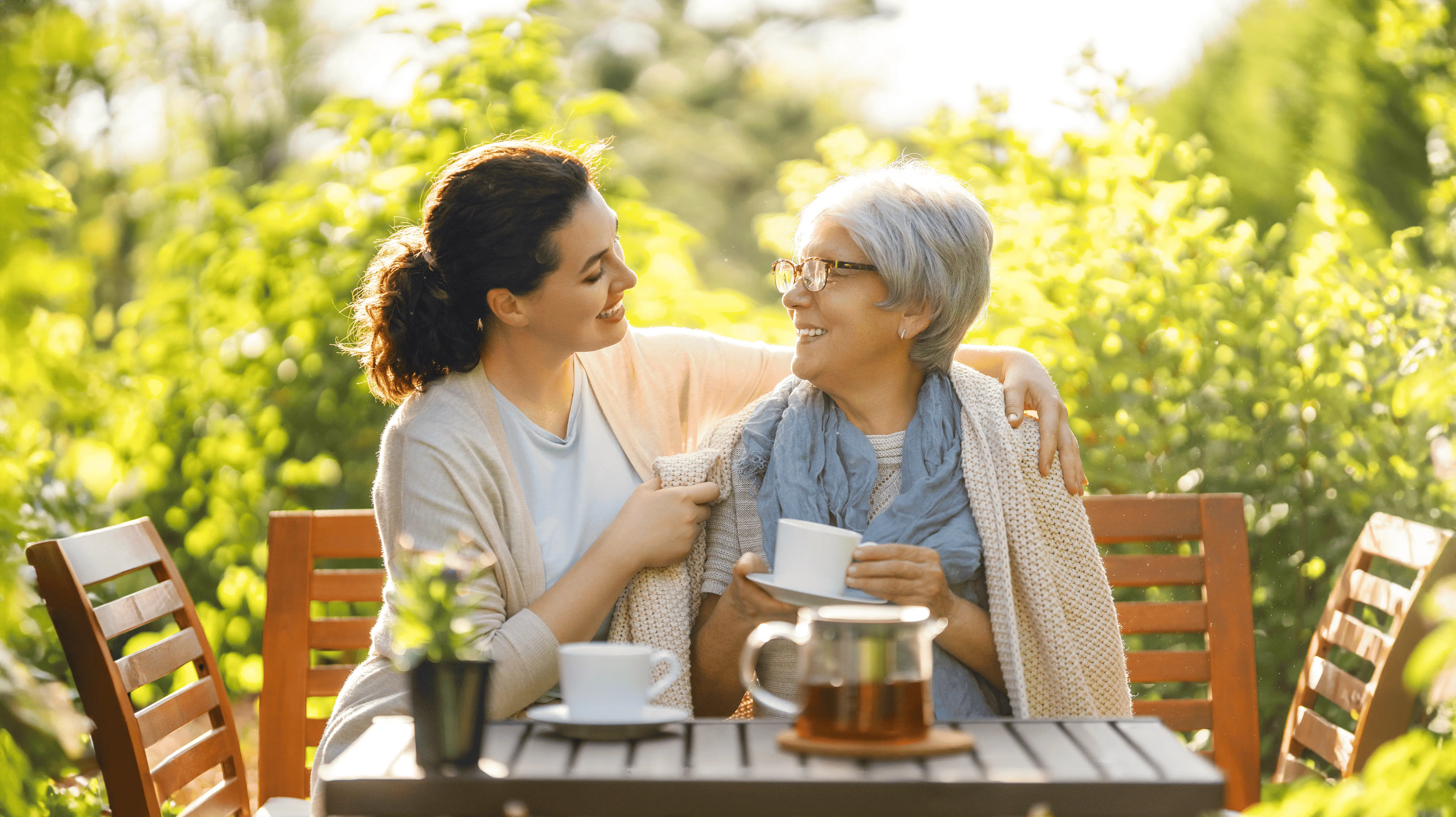 OC Homecare caregiver providing compassionate companion care for a senior in Orange County, CA – sharing smiles and meaningful moments outdoors