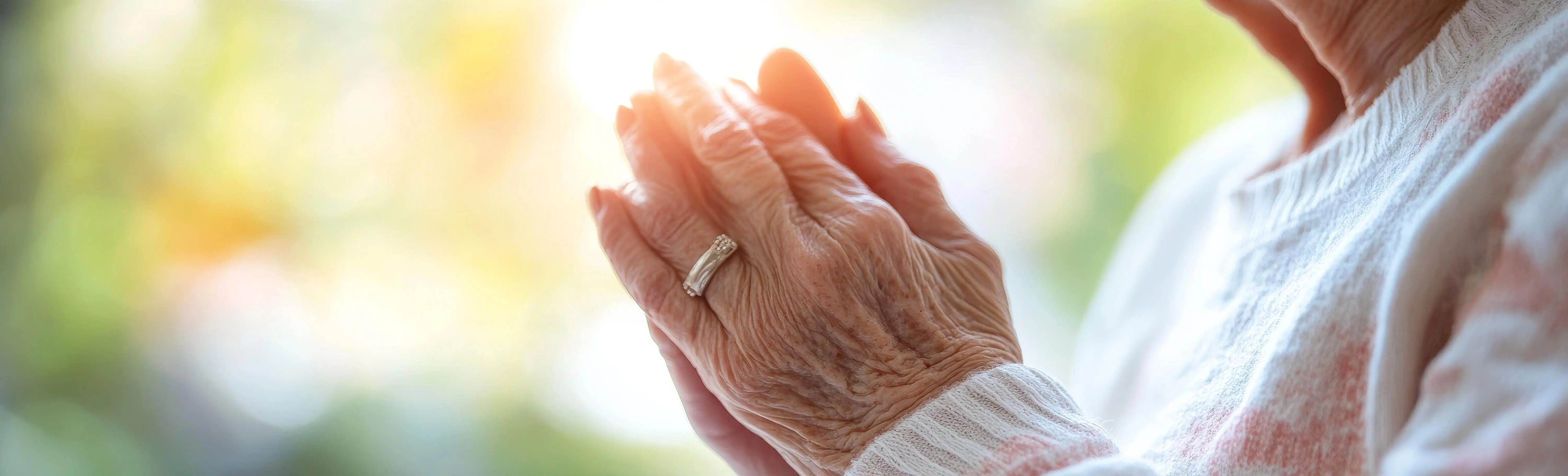 OC HomeCare hospice image in Newport Beach showing elderly hands in prayer — symbolizing peace, dignity, and spiritual comfort during end-of-life care in Newport Beach, CA