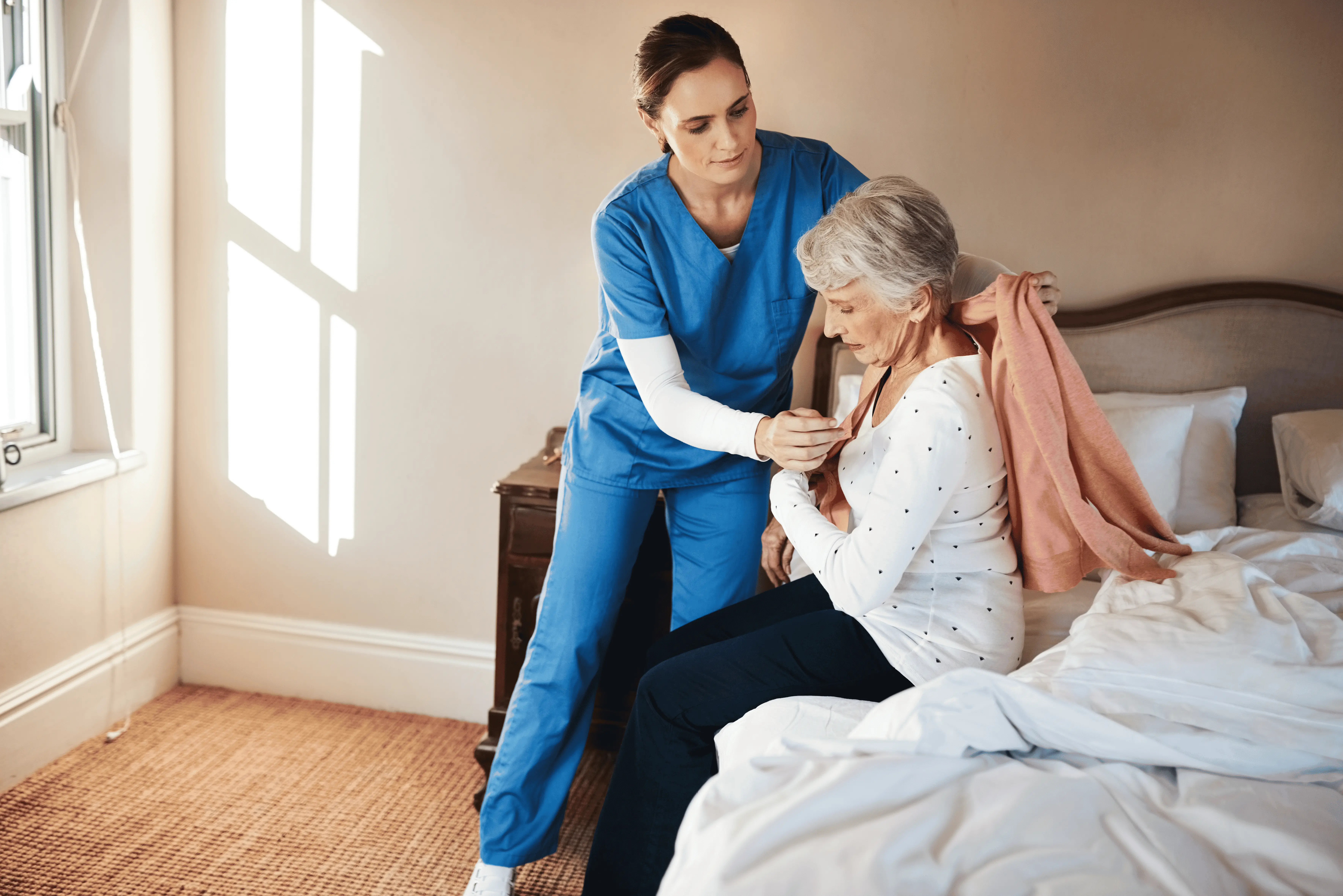 OC Homecare nurse helping senior woman with dressing assistance and mobility support in Orange County home care setting