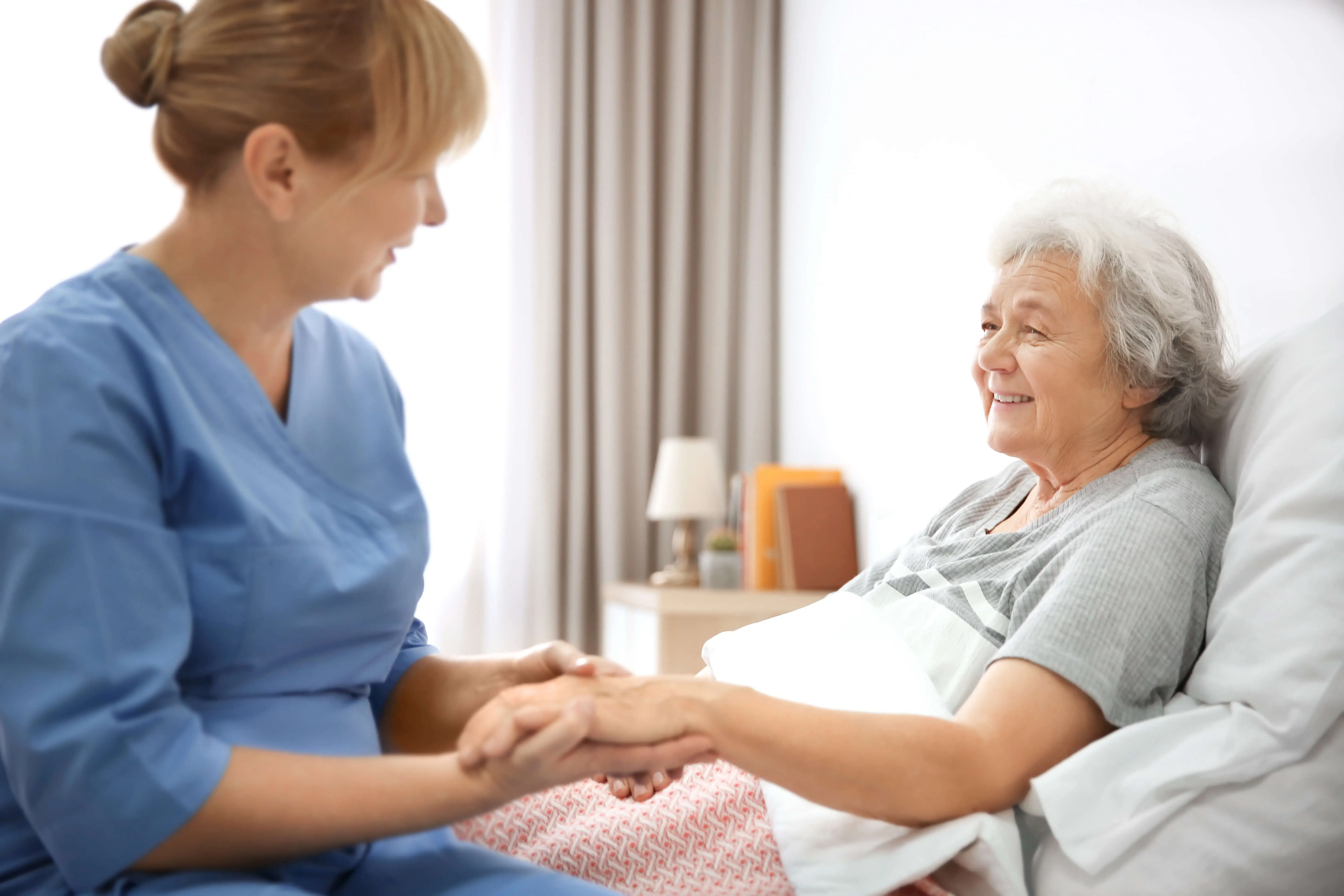 OC HomeCare caregiver in Cypress, CA delivering personalized transitional care to a senior woman during post-hospital recovery at home