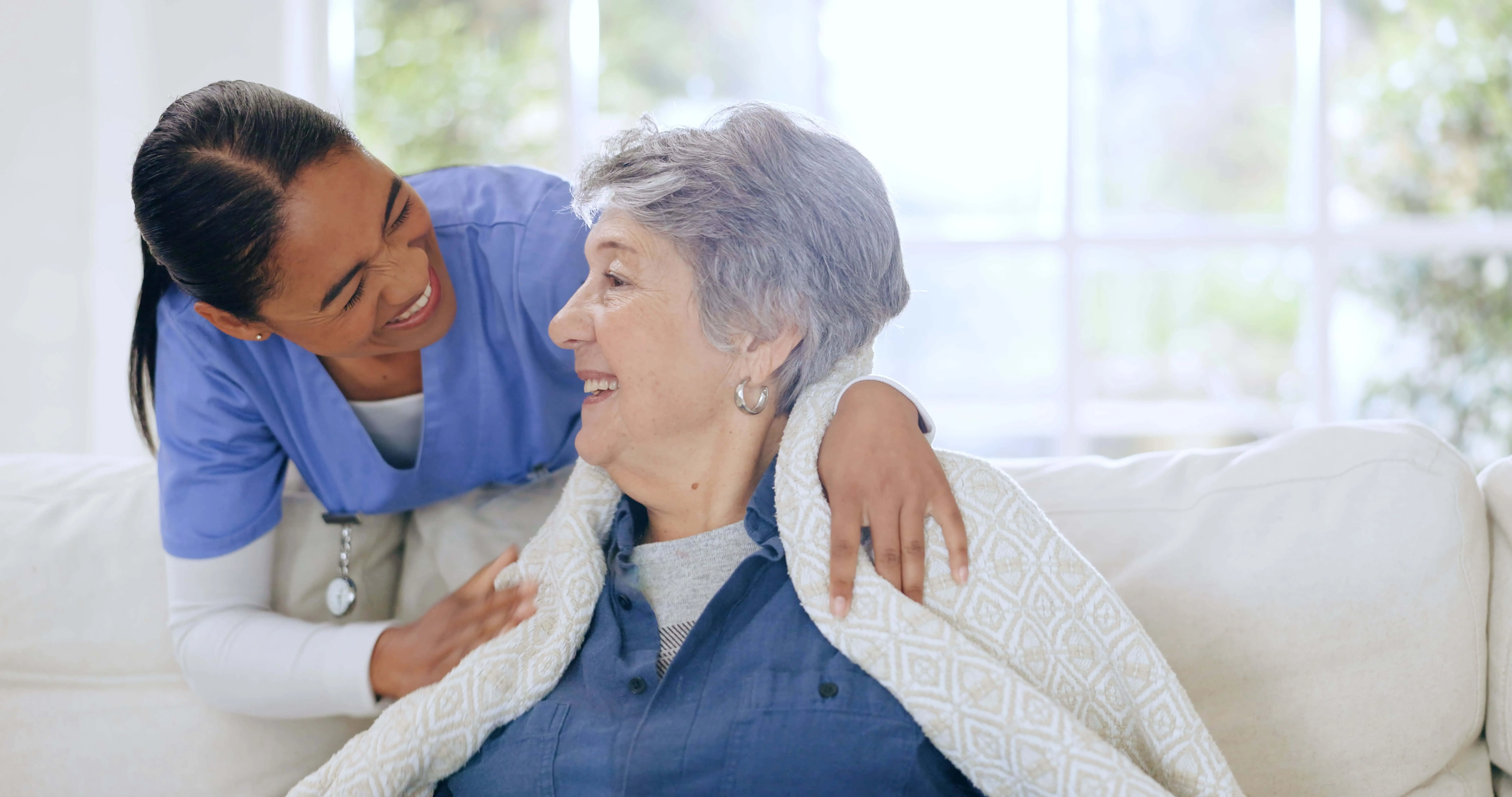 OC HomeCare caregiver offering warm, compassionate in-home senior companion care and support to elderly woman in Placentia, CA